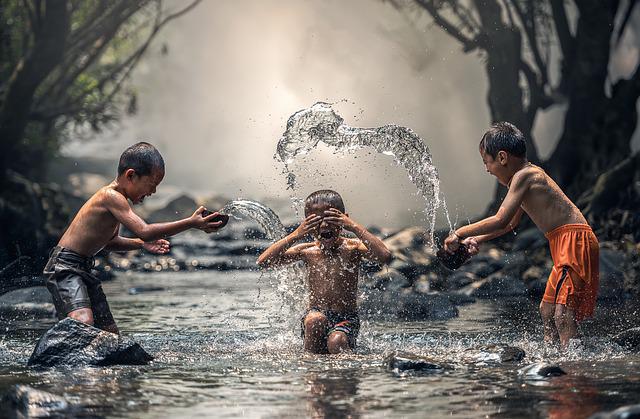 Children playing in water without worrying and thinking we have time