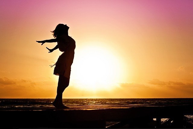 A girl enjoying at the beach and the sunset